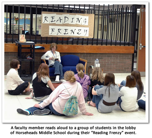 A teacher reads to students during the event.